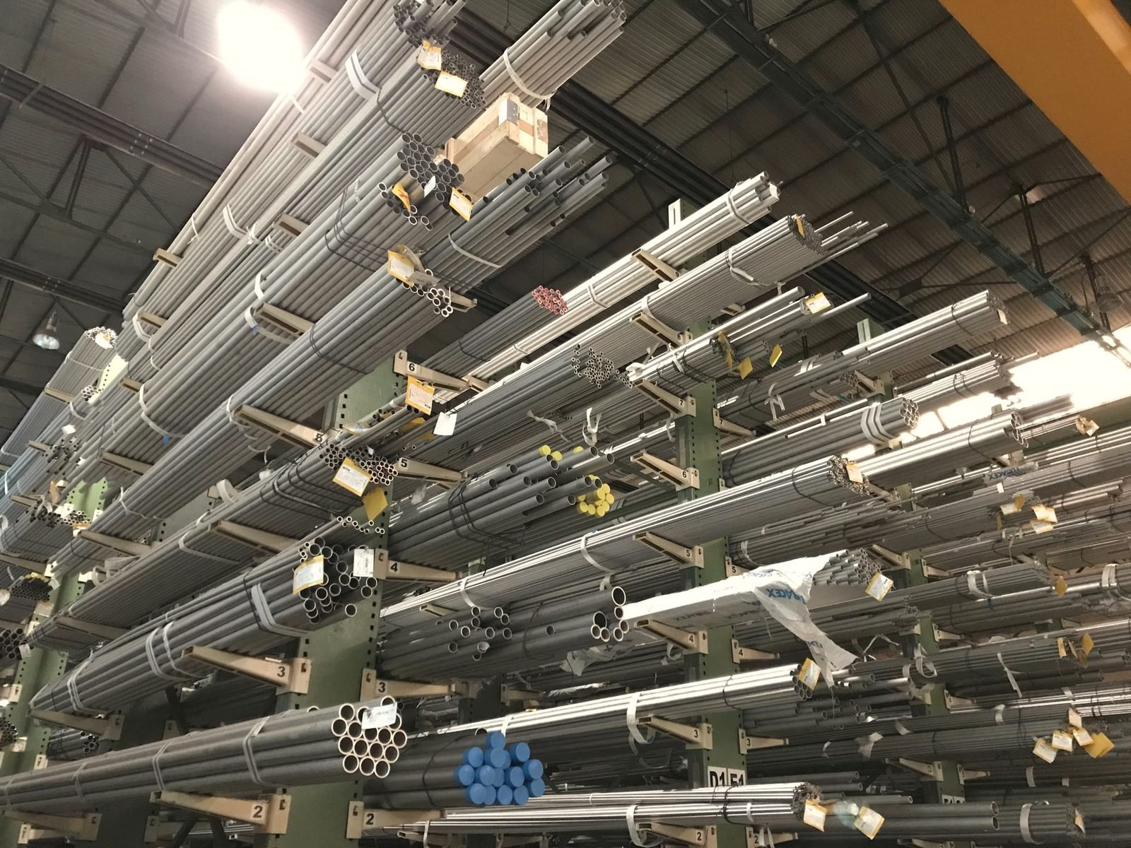 Long steel rods and tubes racked on cantilever arms in a warehouse